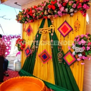 Traditional Haldi Decoration – Yellow & Green Floral Backdrop with Haldi Pool Setup