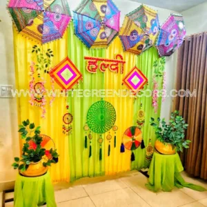 Compact Haldi & Mehndi Decoration – Yellow & Green Backdrop with Colorful Umbrellas
